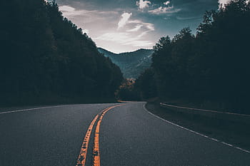 road between trees, asphalt, road, afternoon, street, dark, trees, nature, plants, mountain, sky