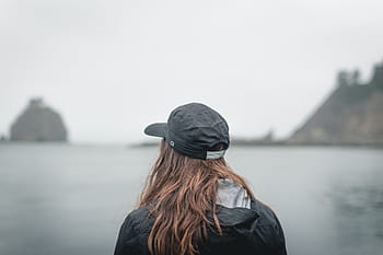 person, facing, body, water, rock isles, black, cap, jacket, front, girl, hat