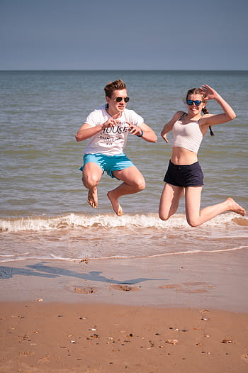 people, jumping, beach, boy, girl, fun, play, ocean, water, sea, shore