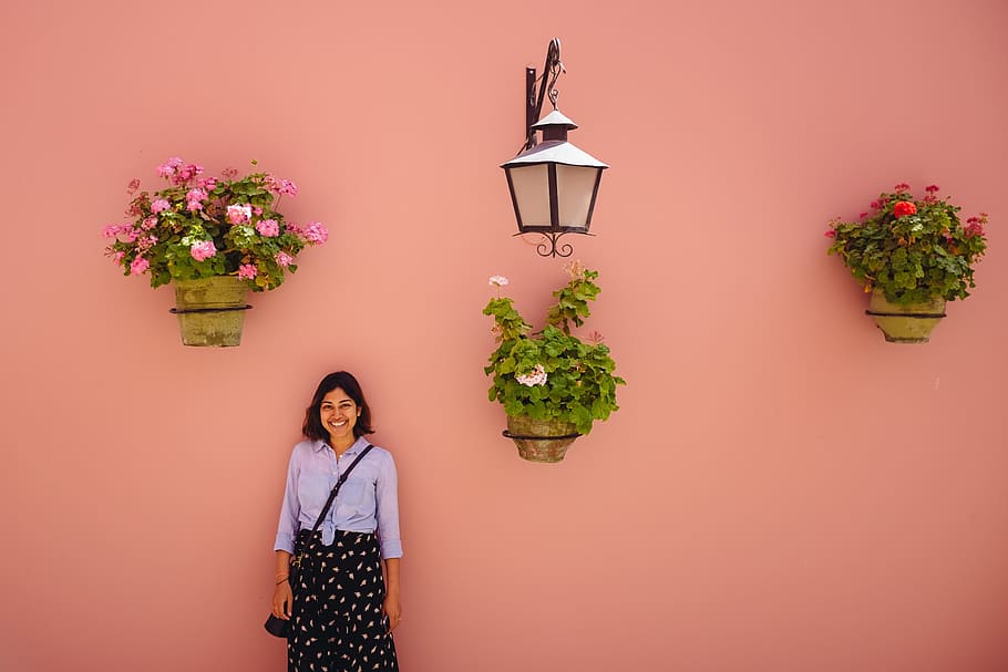 woman, standing, orange, wall, flowers, people, smile, enjoy, happy, plants, green