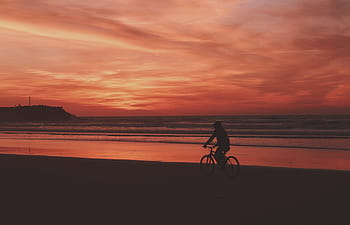 silhouette, person, riding, bicycle, traveling, beach shore, bike, dark, sea, ocean, clouds