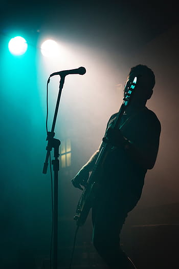 man, playing, bass guitar, standing, front, microphone, people, guitar, concert, lights, party
