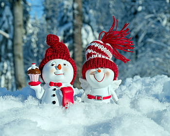 two, white-and-red snowman figurines, standing, snow field, snowmen, fun, figure, funny, cap, snow face, winter