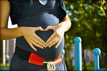 person touching stomach, pregnant, tummies, heart, in anticipation of the