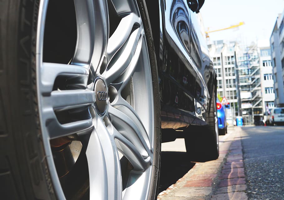 black, audi vehicle, parked, sidewalk, auto, car rim, rim, wheel, metal, spokes, wheels and tires