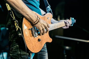 person, holding, brown, electric, guitar, green, strap, band, singer, microphone, micro