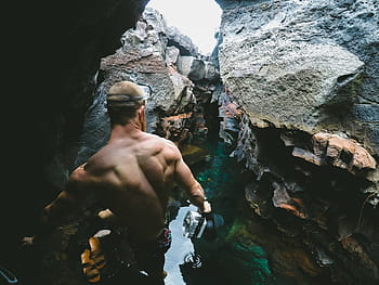 man, climbing, rock, person, rocky, surface, near, body, water, daytime, people