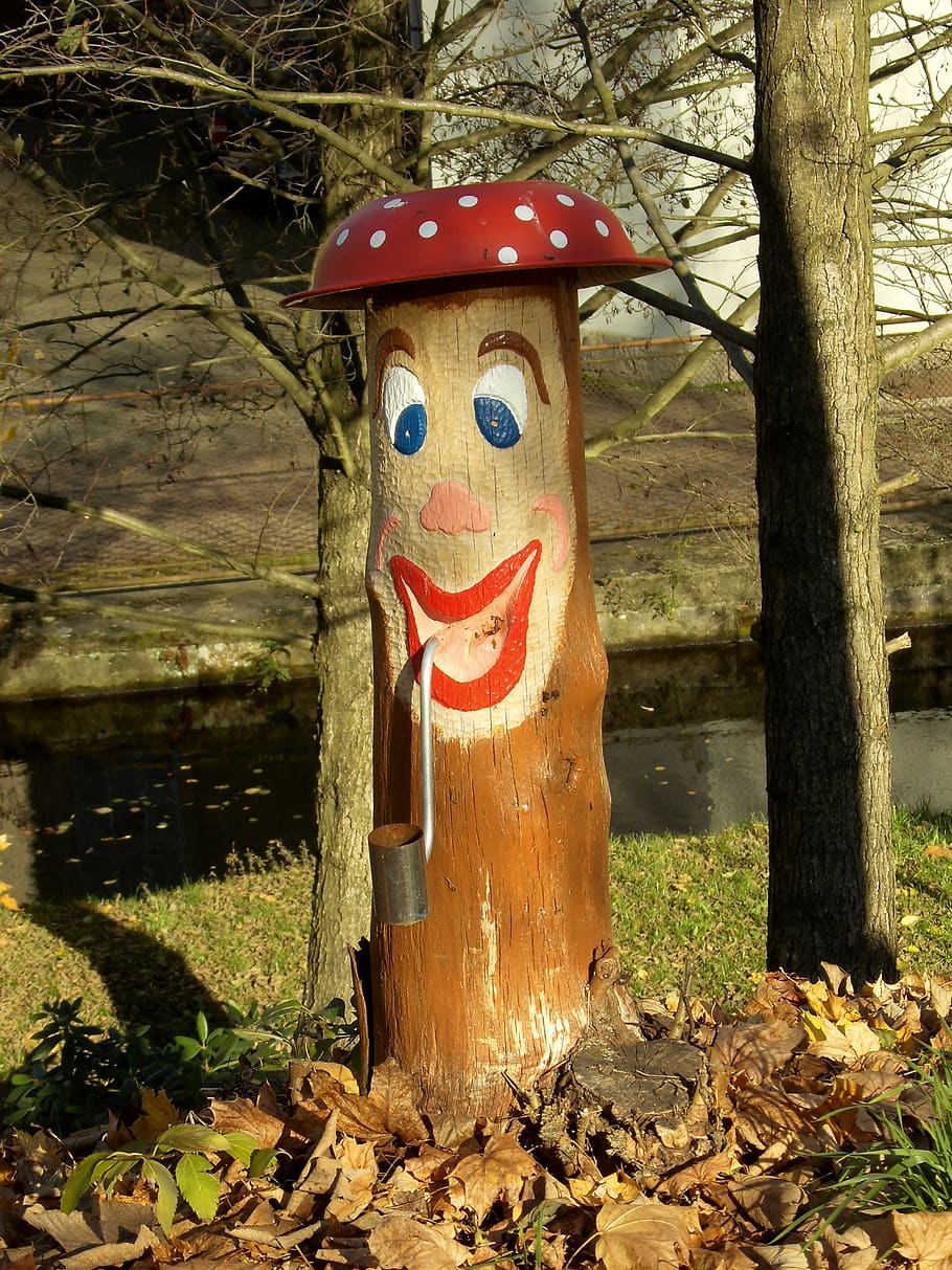 tree, log, wood, face, painted, hat, ashtray, smoking island