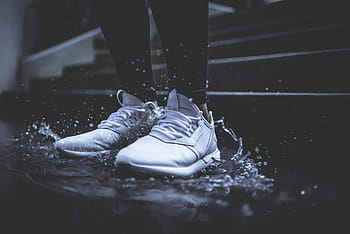 person, wearing, pair, white, low-top sneakers, athletic, shoes, standing, ladder, splash, water