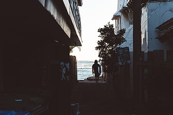 woman, walking, houses, sea shore, walking in between, people, outdoors, urban Scene, street, building exterior, built structure