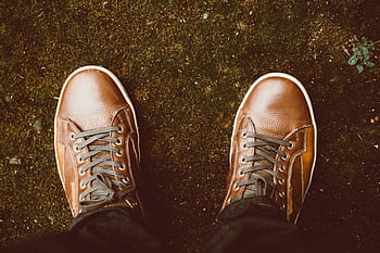 person, wearing, pair, brown, leather lace-up sneakers, standing, soil ground, leather, shoes, footwear, travel