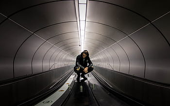 man, sitting, gray, hallway, black, hoodie, crouching, top, train, black and white, tunnel