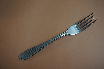stainless, steel fork, brown, surface, fork, metal, steel, table, thing, utensil, solid