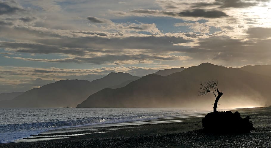 beach, mountains, sunlight, ocean, sea, waves, shoreline, coast, nature, outdoors, sky