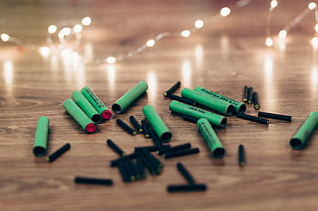 closeup, black, green, firecrackers, brown, wooden, surface, plastic, material, reflection, indoors