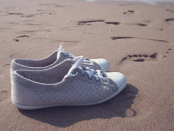 pair, gray-and-white low-top sneakers, sand, daytime, gray, white, low, tops, sneakers, brown, shoes