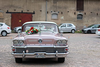 classic, pink, vehicle, parked, brown, bricked building, daytime, oldtimer, buick, american, automotive