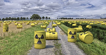 yellow, metal tank containers, green, grass field, nuclear waste, radioactive trash, for final, nuclear waste casks, barrels, composing, garbage