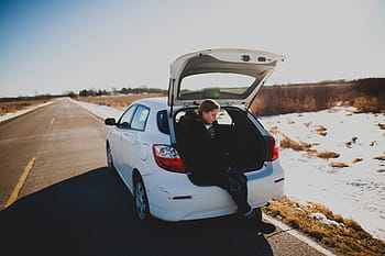 woman, sitting, car luggage compartment, girl, white, door, hatchback, parked, ahead, dirt, road
