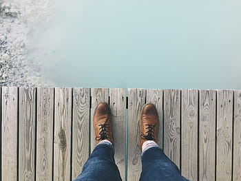 person, wearing, brown, dress shoes, standing, grey, wooden, dock planks, shoes, knot, footwear