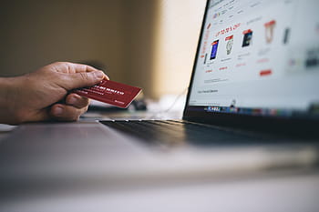 person, holding, red, card, front, laptop, ecommerce, shopping, credit card, payment, money
