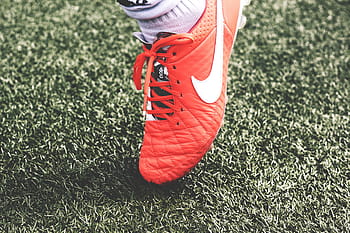 person, wearing, quilted, red, nike cleat, unpaired, nike, cleat, grass, soccer, cleats