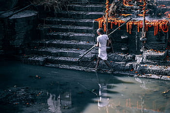 man, standing, holding, spare, water, people, walking, outdoor, reflection, rocks, stair