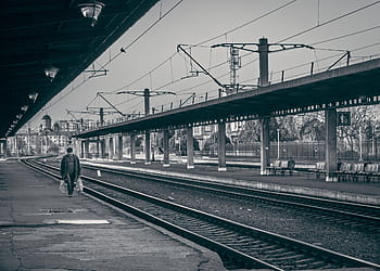 concrete, bridge, day time, grayscale, photography, person, holding, white, plastics, walking, railways