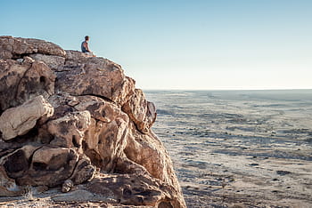 person, sitting, cliff, mountain, man, edge, nature, landscape, rocks, ground, soil
