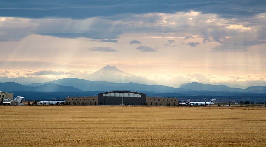 planes by structure, airport, landscape, planes, hangar, mountains, rays of light, sunlight, clouds, atmospheric, travel