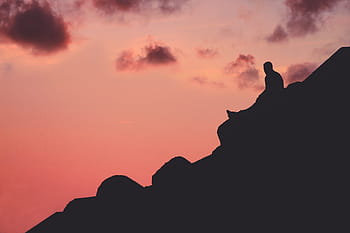 silhouette photo, person, rock, mountain, dark, sky, clouds, sunset, people, sitting, alone