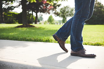 person, wearing, brown, leather dress shoes, blue, denim, jeans, walking, sidewalk, shoes, pants