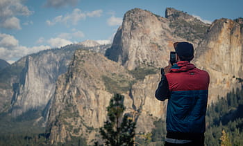 man, standing, taking, mountain, nature, mountains, sky, clouds, people, guy, phone