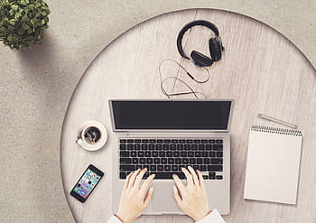 person, hand, grey, laptop computer, notepad, mobile phone, notebook, table, headphones, coffee, hands