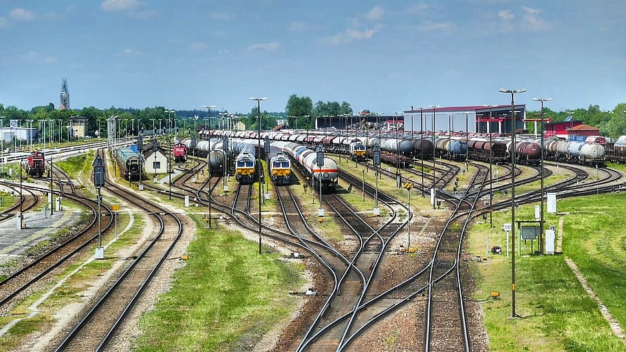 assorted-colors trains, clear, blue, sky, daytime, transport system, industry, train, railway line, travel, railway