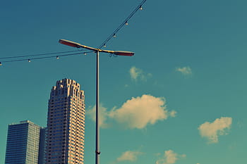 street light, building, way, street, light, near, two, gray, buildings, blue, sky