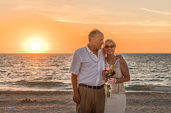 man, wearing, white, dress shirt, woman, yellow, floral, tank, top, standing, shoreline