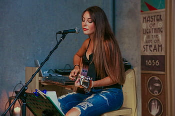 woman, playing, guitar, sitting, chair, microphone, next, people, singing, girl, beauty