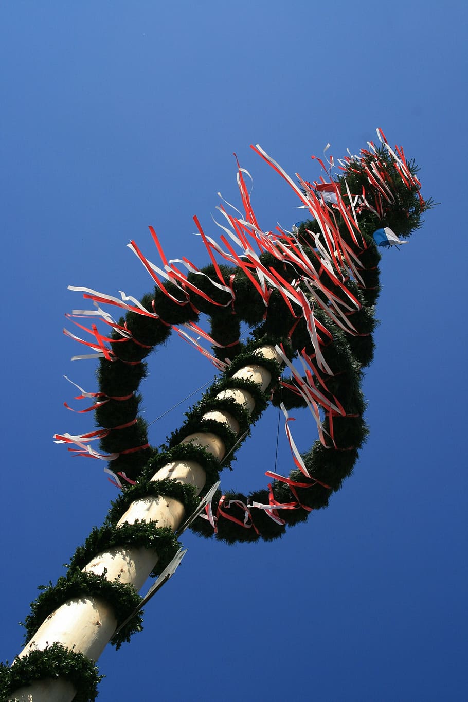 low-angle photography, brown, green, pole, clear, sky, daytime, maypole, spring, tradition, blue