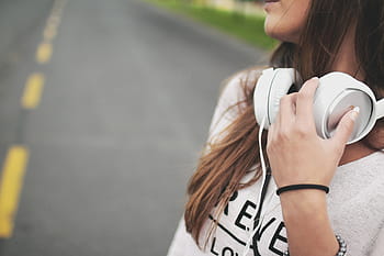 woman, wearing, white, top, corded, headphones, shirt, holding, ear, music, girl