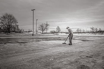 grayscale photography, man cleaning pavement, man, sweeping, floor, grayscale, broom, cleaning, concrete, lot, one person