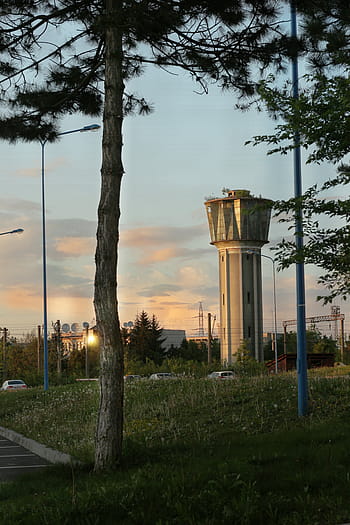 tower near trees, blue, street, light, architecture, building, structure, sky, clouds, sunset, sunrise