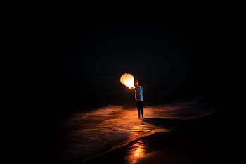 person, holding, paper lantern, black, background, lantern, night, dark, light, balloon, sea