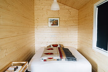 wood, log cabin, bed, sheets, pillow, frame, window, shades, light, covers, room