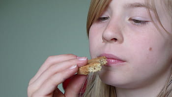 face, consider, thinking, look at pages, viewing, biscuit, eat, food, nutrition, taste, smell