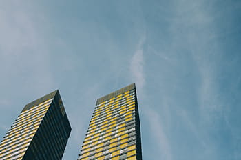 low-angle photography, yellow, building, architecture, infrastructure, blue, sky, skyscraper, tower, day, low angle view
