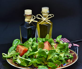 vegetable salad, olive, oil bottles, lamb's lettuce, arugula, bacon, diced bacon, tomato, oil, olive oil, walnut oil