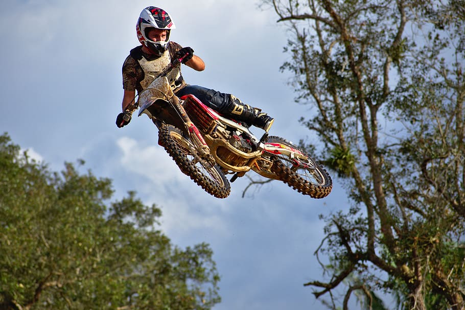 man, riding, dirt bike, airborne, whip, ramp, jump, nature, wood, sky, outdoorsman