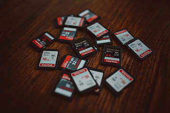 camera, Memory cards, technology, gambling, indoors, wood - material, table, large group of objects