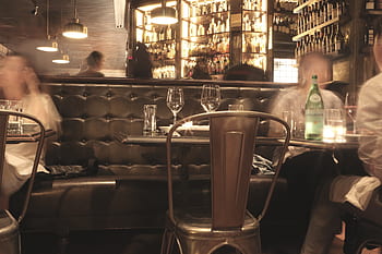 restaurant, dining, table, chairs, wine glasses, plates, utensils, lights, bottles, alcohol, eating